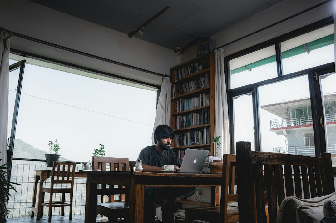 man coding on laptop at home