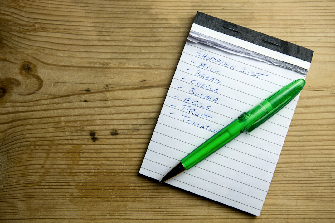 Notebook with handwritten planning notes and a pen