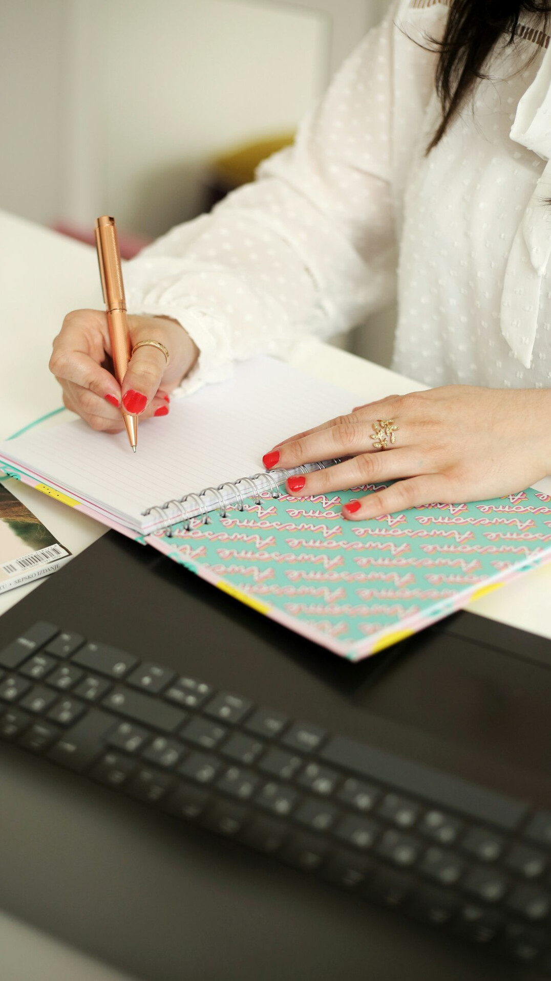 woman writing code on notebook